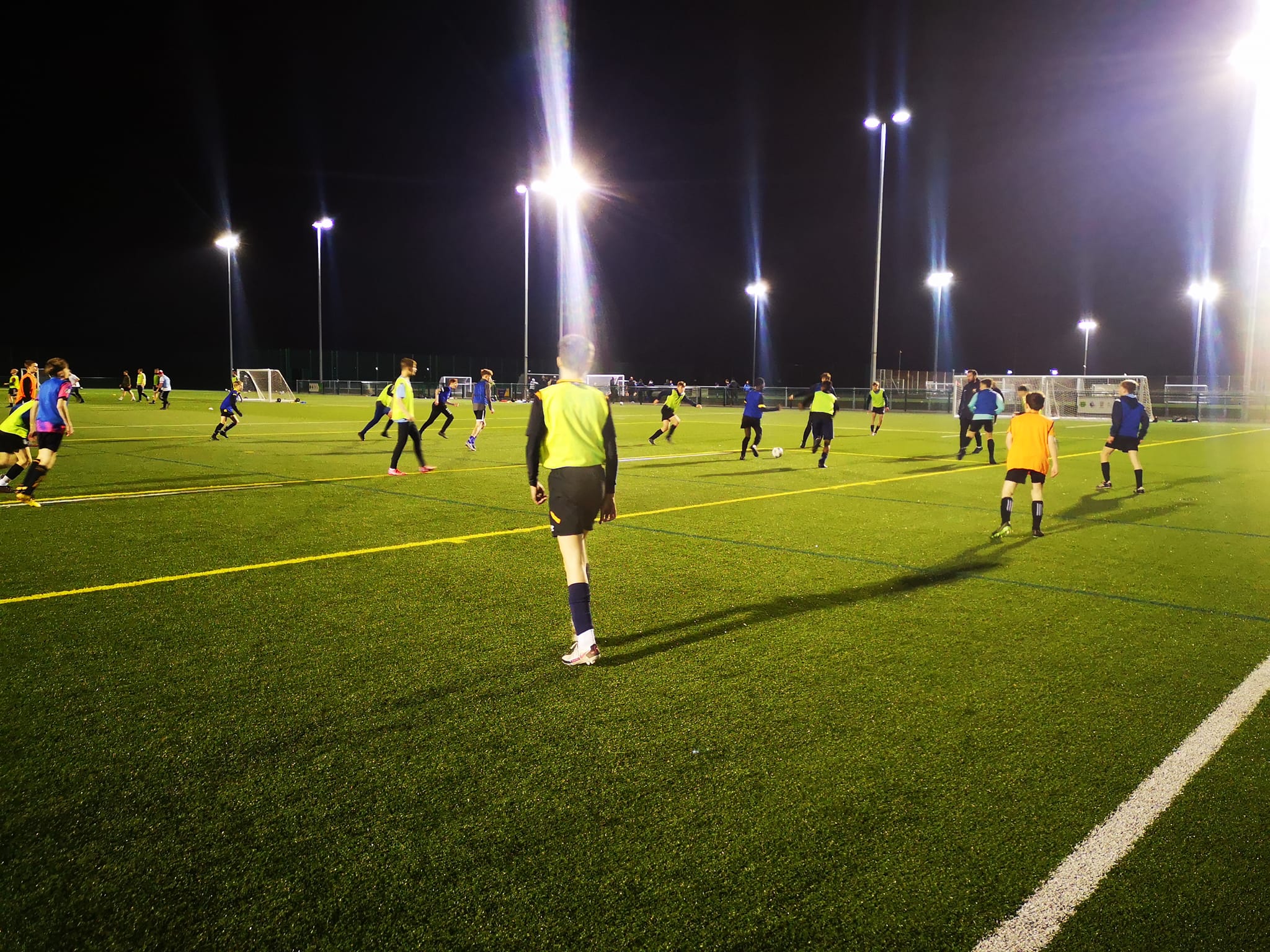 Professional football academy coaches reviewing squad electronic physical performance data charts