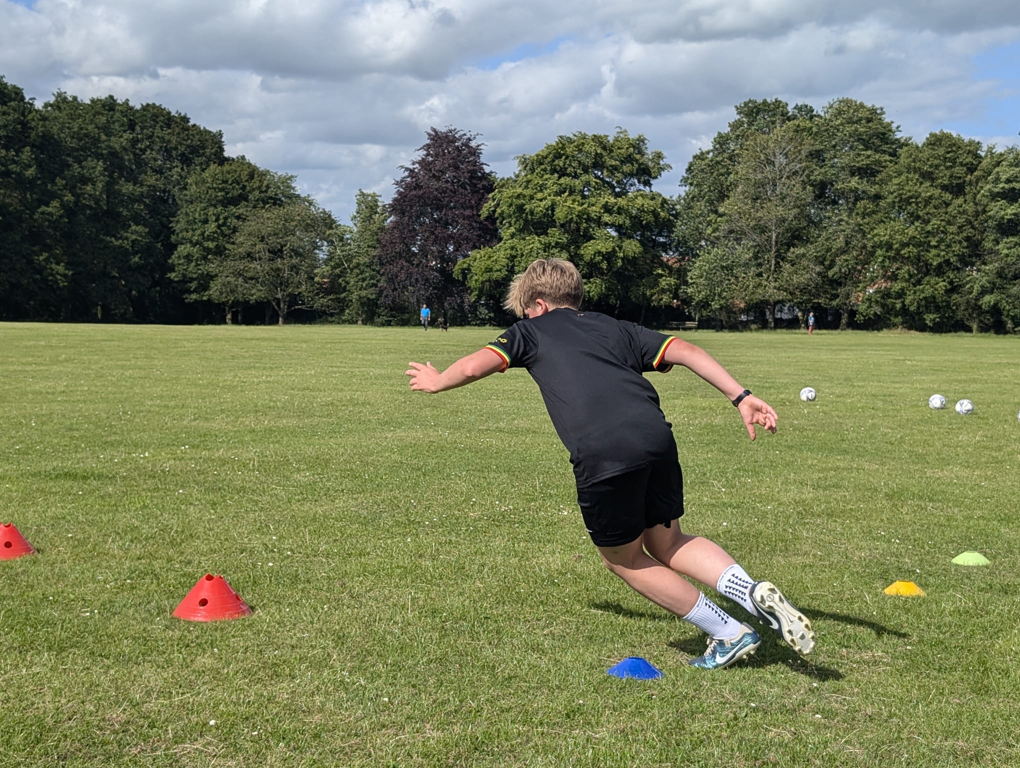 Individual football player running a 10 meter sprint test through timing gates