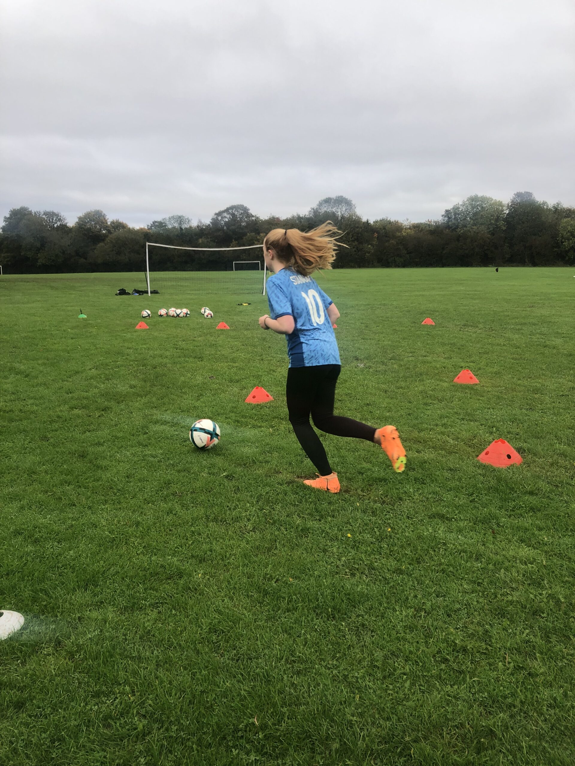 Private football training coach tracking dynamic sprints